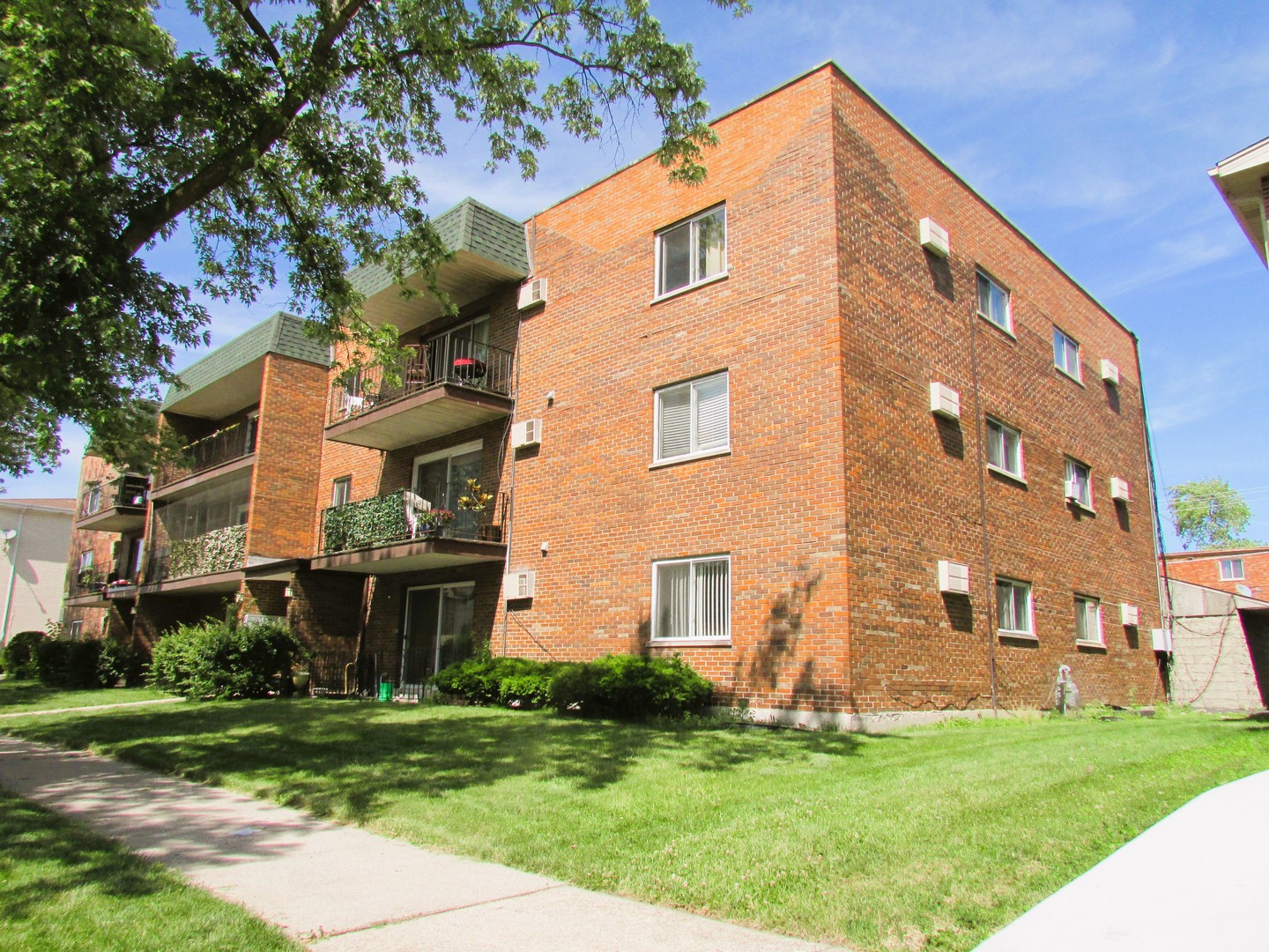 10611 Parkside Avenue, Unit 202 Chicago Ridge, IL 60415 - Photo 1 of 22 a view of a building with a yard