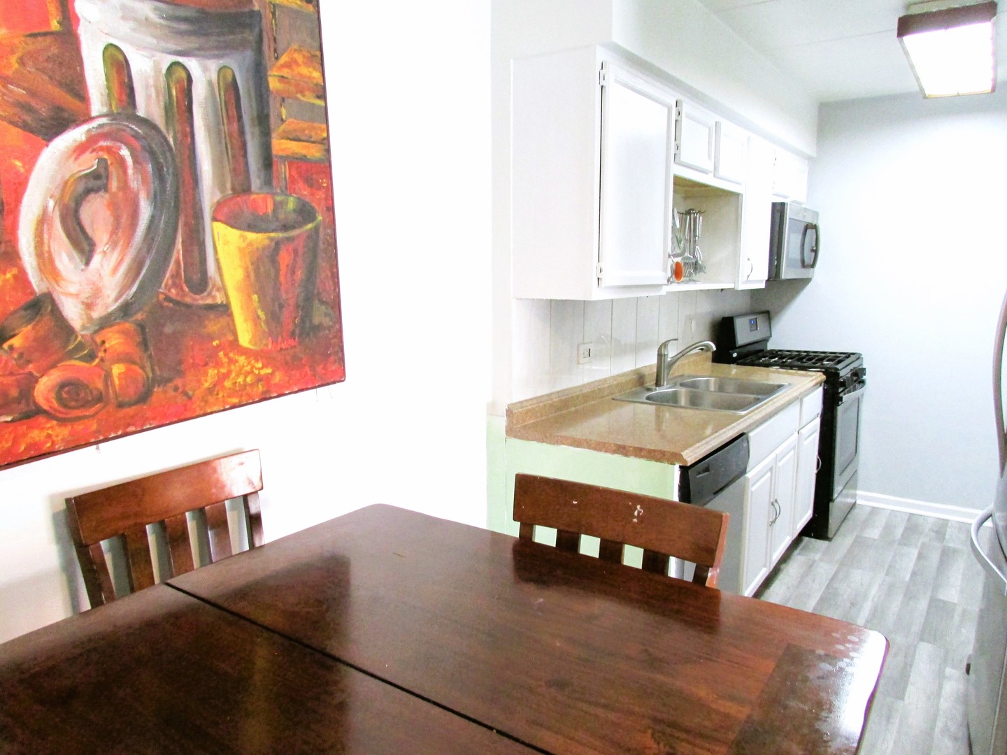 10611 Parkside Avenue, Unit 202 Chicago Ridge, IL 60415 - Photo 2 of 22 a living room with furniture and a table