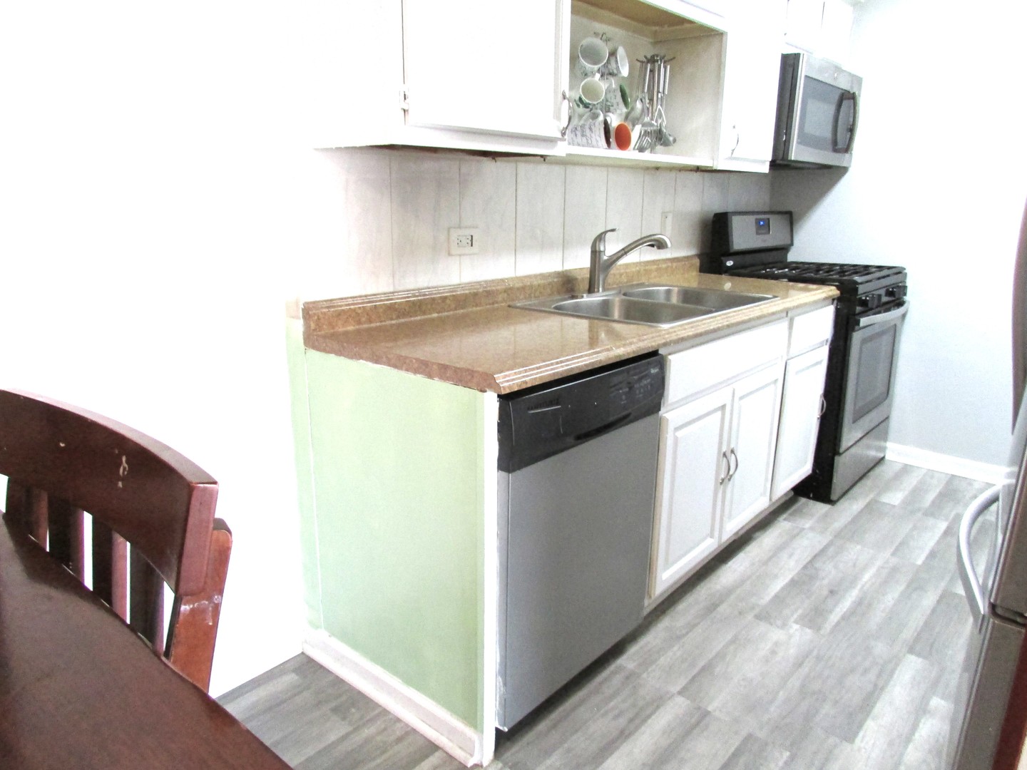 10611 Parkside Avenue, Unit 202 Chicago Ridge, IL 60415 - Photo 3 of 22 a kitchen with a sink a stove and cabinets