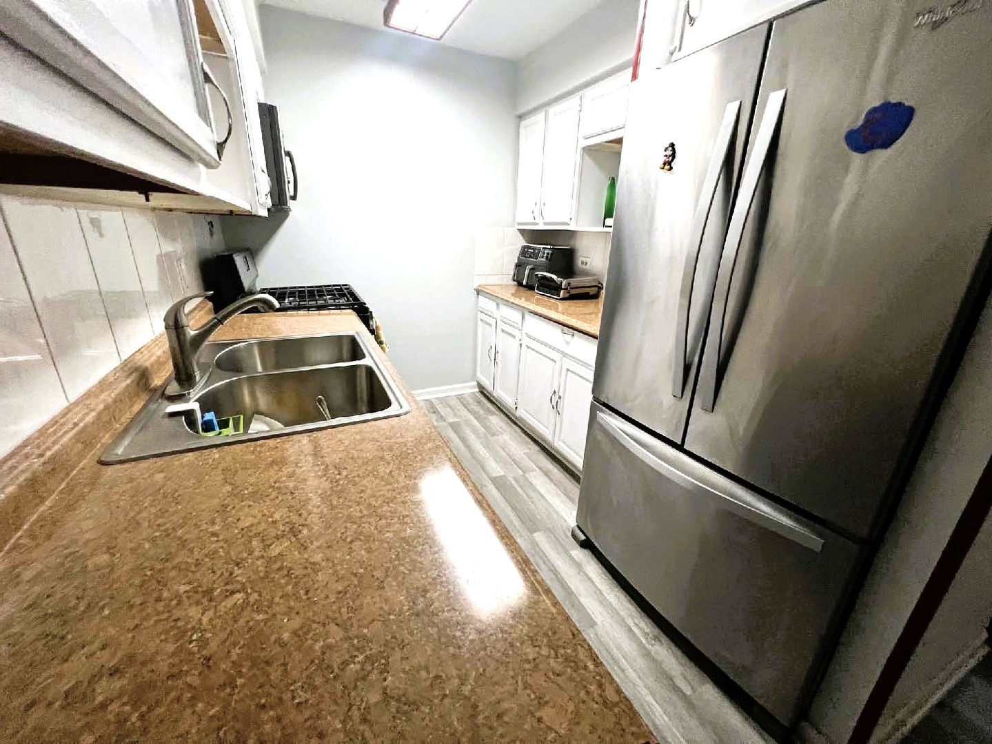 10611 Parkside Avenue, Unit 202 Chicago Ridge, IL 60415 - Photo 6 of 22 a white refrigerator freezer sitting inside of a kitchen