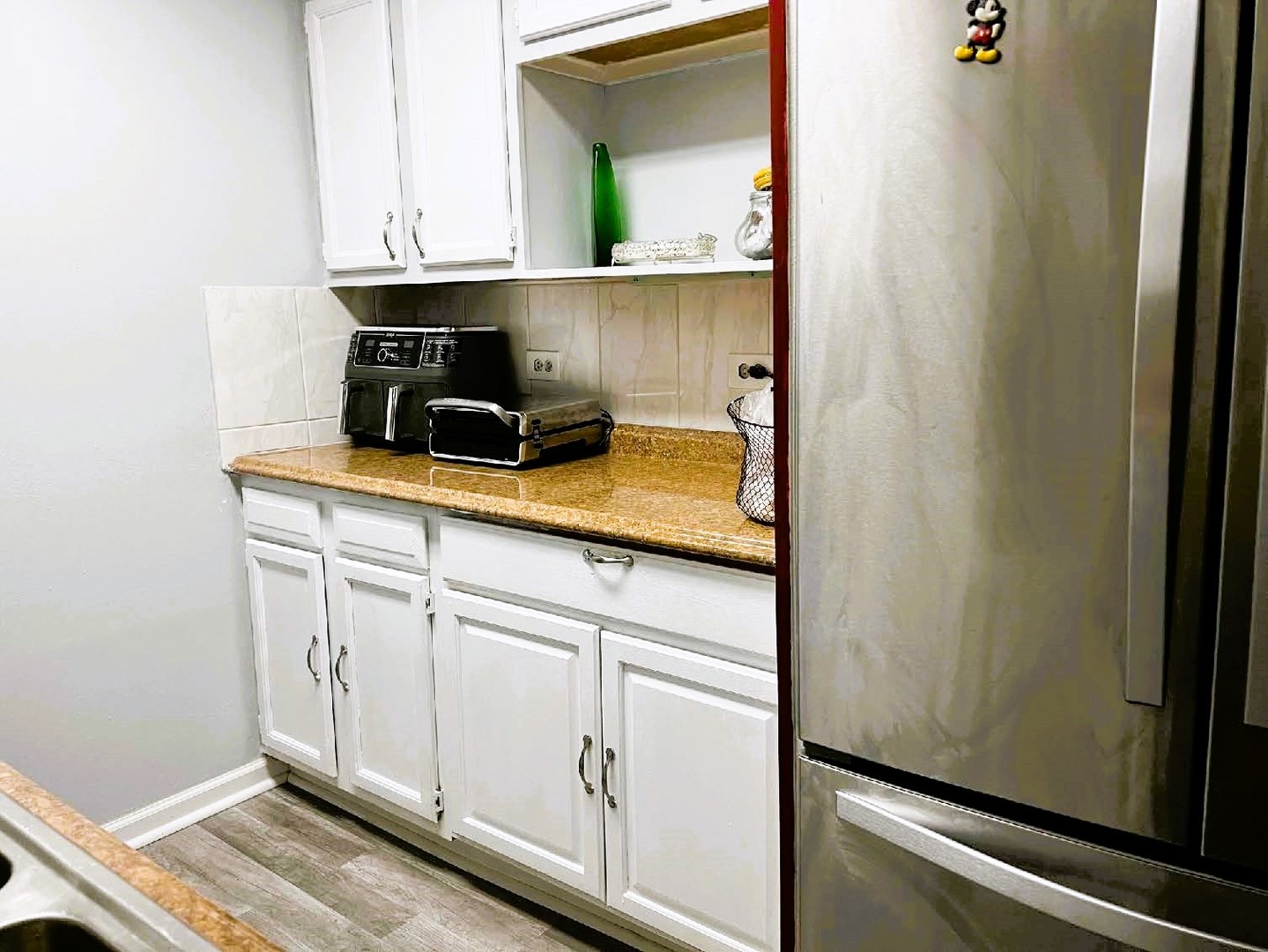10611 Parkside Avenue, Unit 202 Chicago Ridge, IL 60415 - Photo 7 of 22 a kitchen with white cabinets and a sink