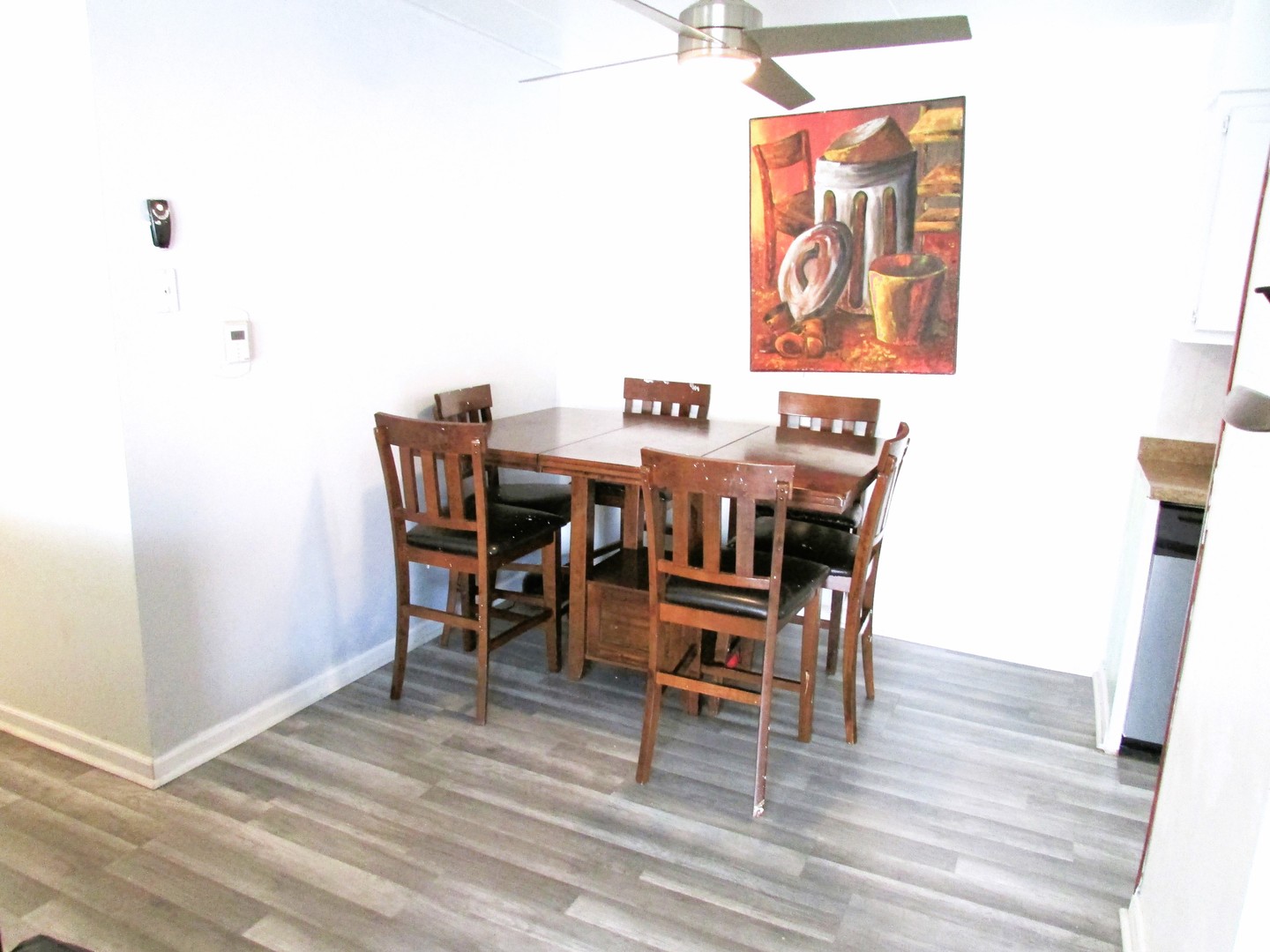 10611 Parkside Avenue, Unit 202 Chicago Ridge, IL 60415 - Photo 9 of 22 a dining room with furniture and wooden floor
