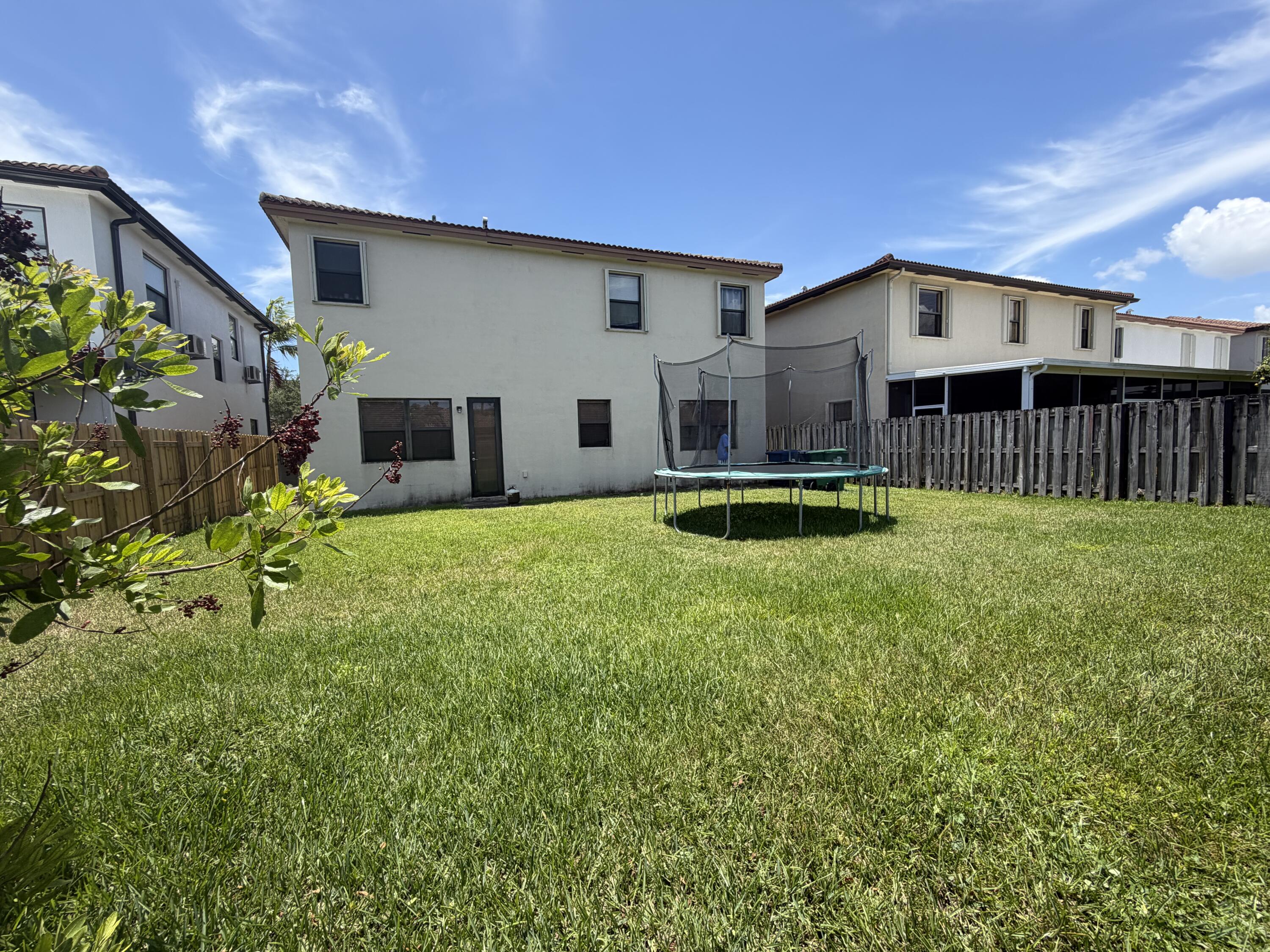 10463 Southwest 228th Terrace Miami, FL 33190 - Photo 2 of 8 a house view with a garden space