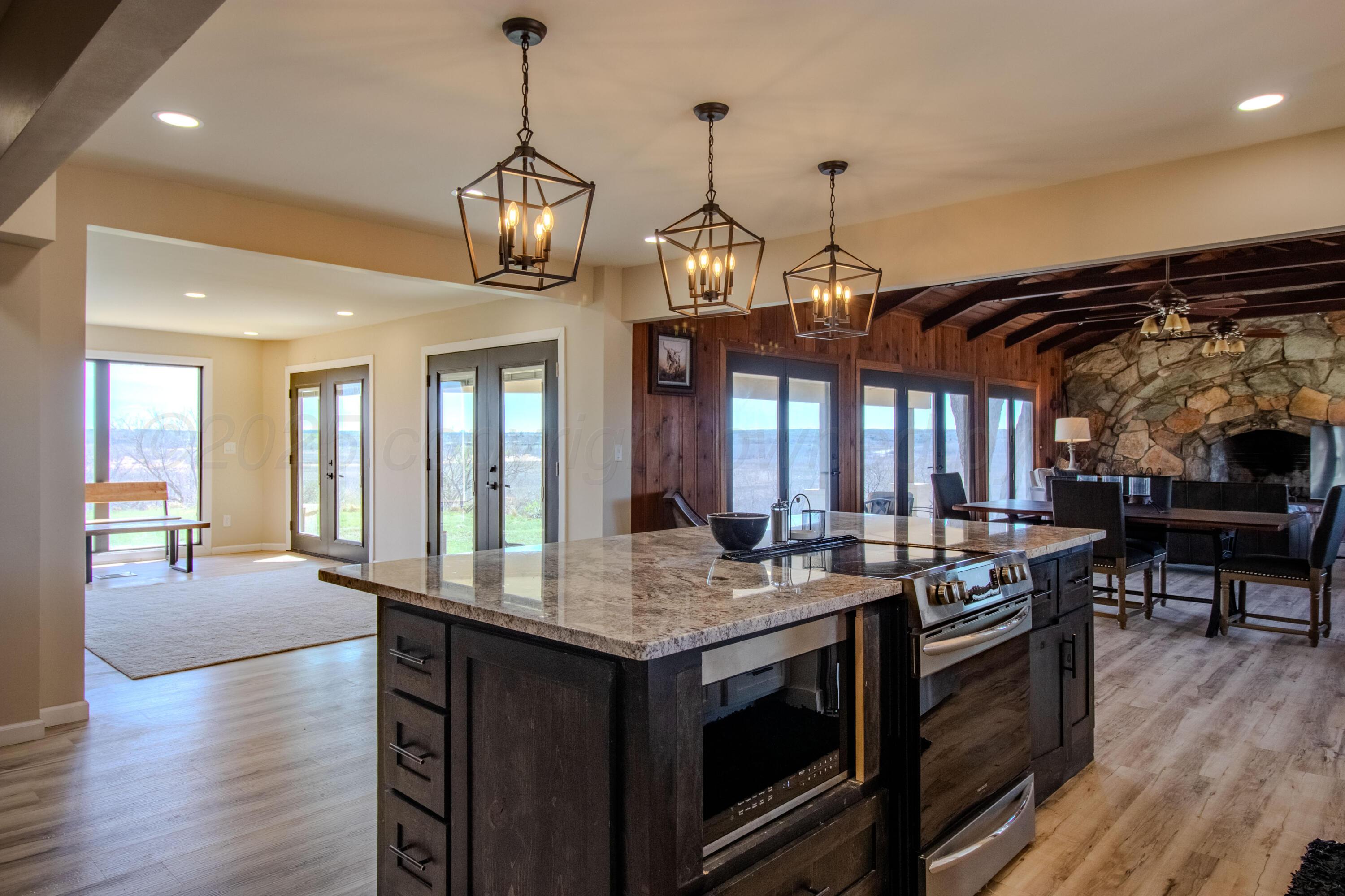 401 10 Bears Trail Howardwick, TX 79226 - Photo 13 of 71 a kitchen with stainless steel appliances granite countertop a stove a sink and a wooden floors