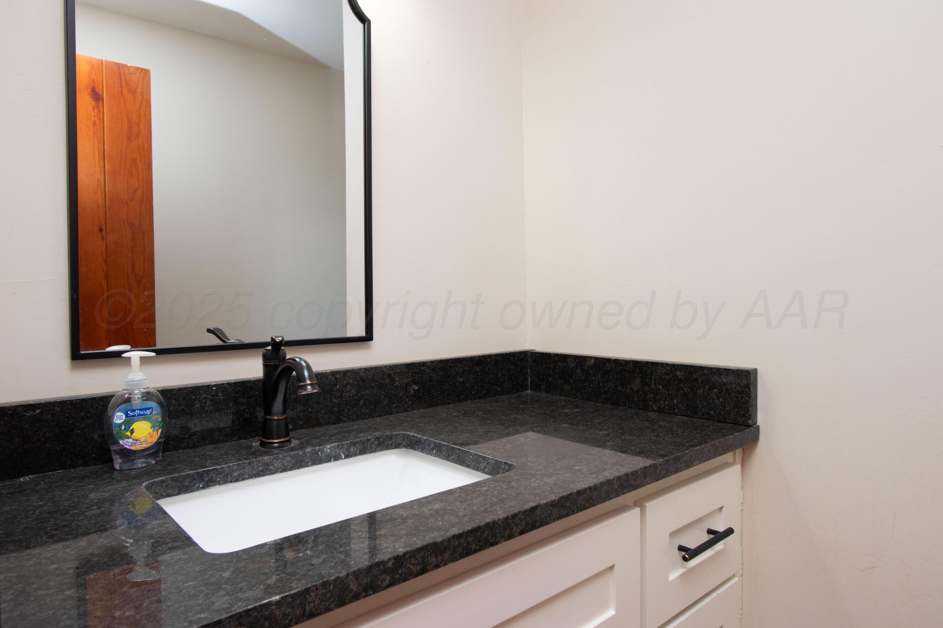 401 10 Bears Trail Howardwick, TX 79226 - Photo 20 of 71 a bathroom with a granite countertop sink and a mirror