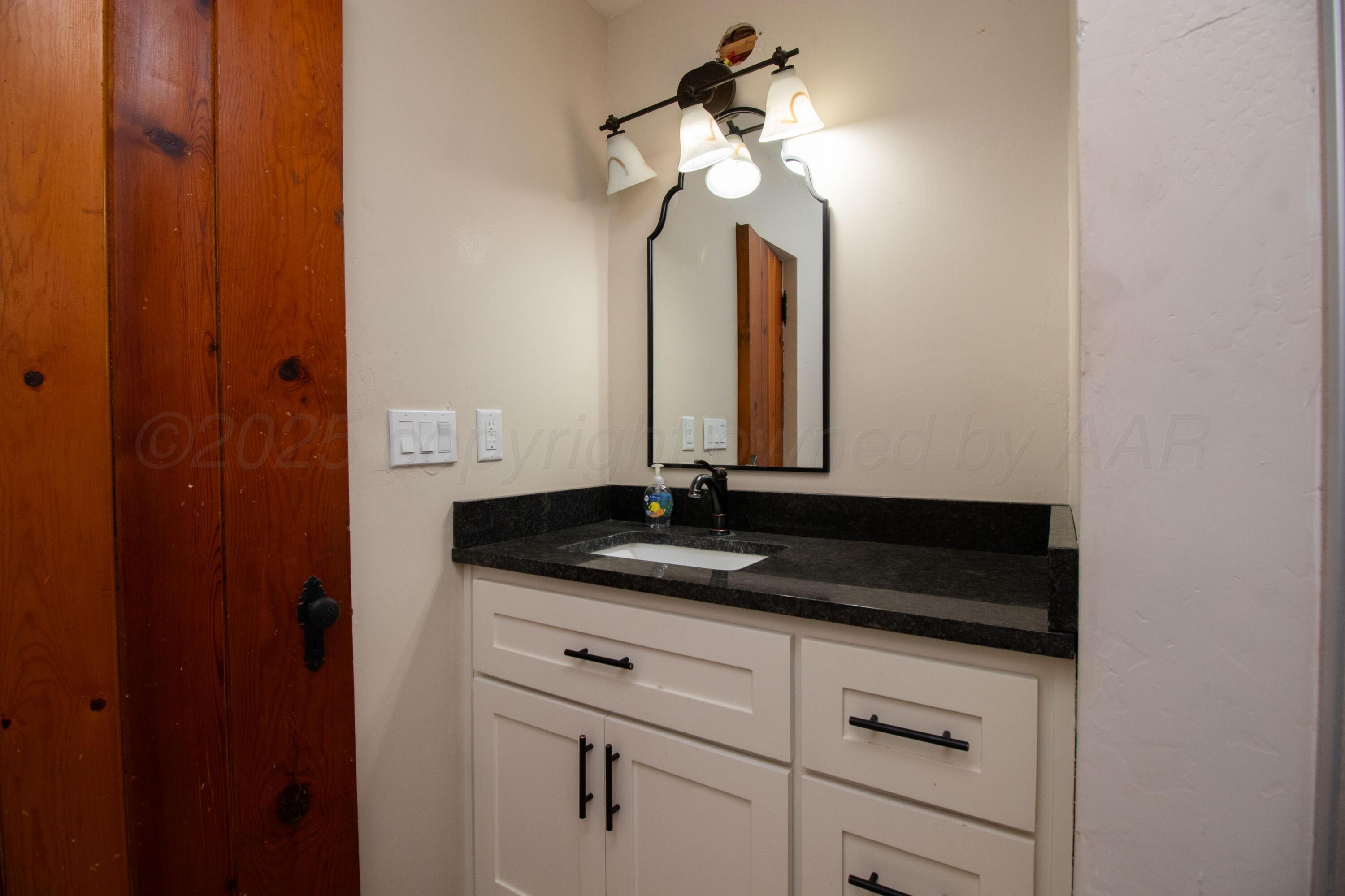 401 10 Bears Trail Howardwick, TX 79226 - Photo 22 of 71 a bathroom with a granite countertop sink and a mirror