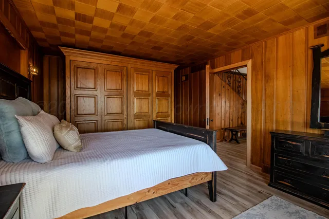 a bedroom with a large bed and a large window