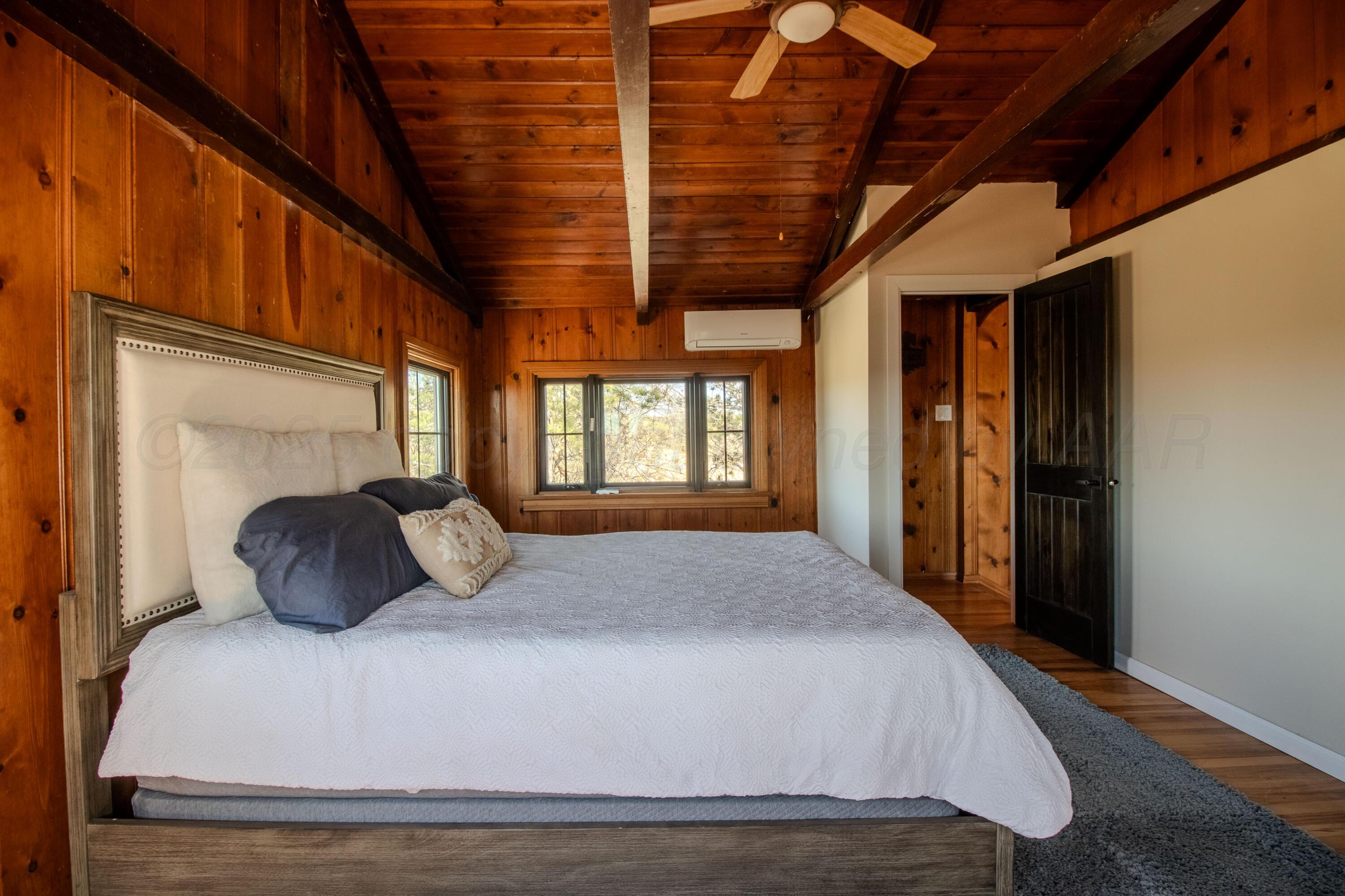401 10 Bears Trail Howardwick, TX 79226 - Photo 28 of 71 a bedroom with a large bed and a large window