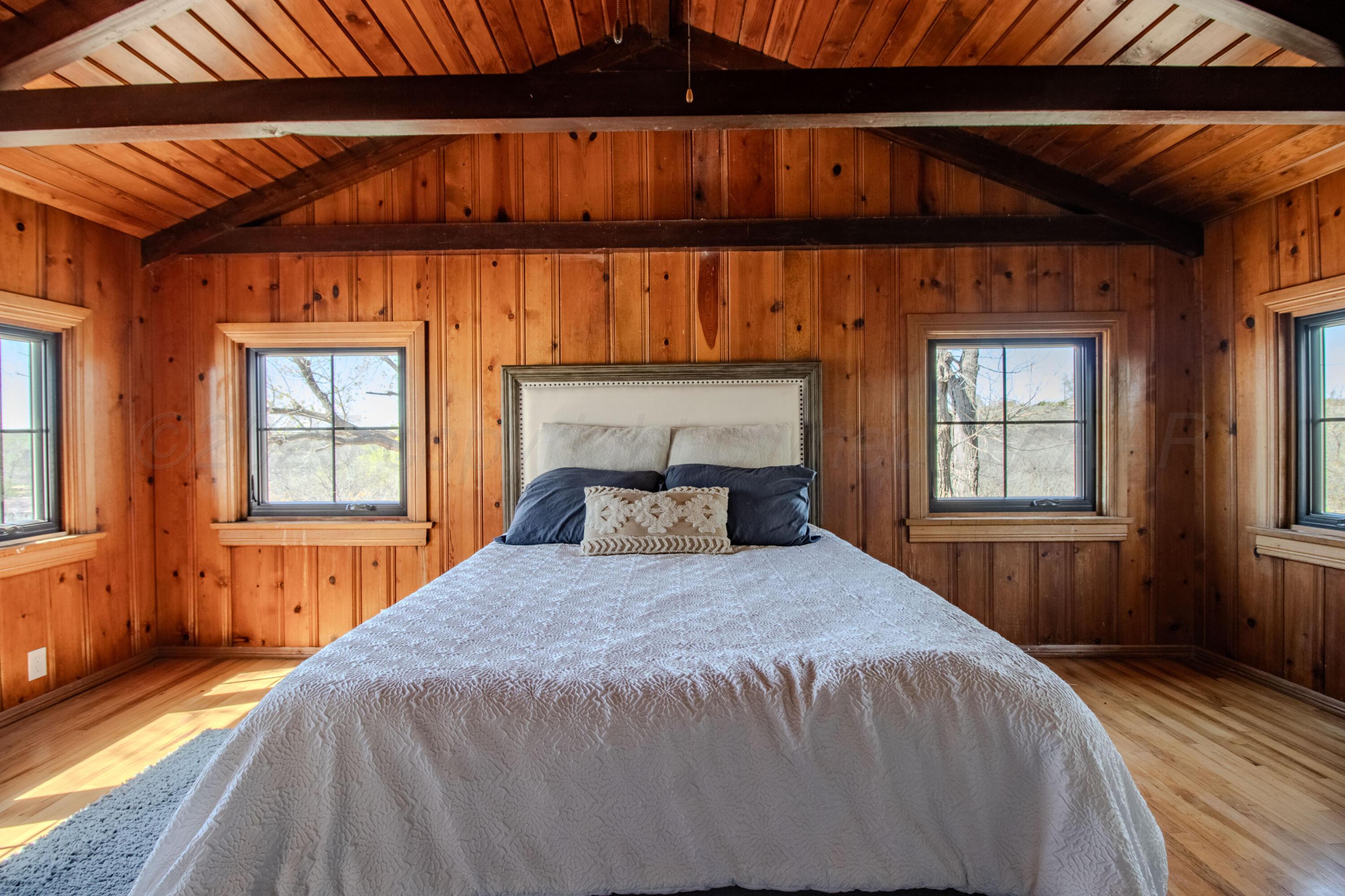 401 10 Bears Trail Howardwick, TX 79226 - Photo 29 of 71 a bedroom with a bed and wooden floor