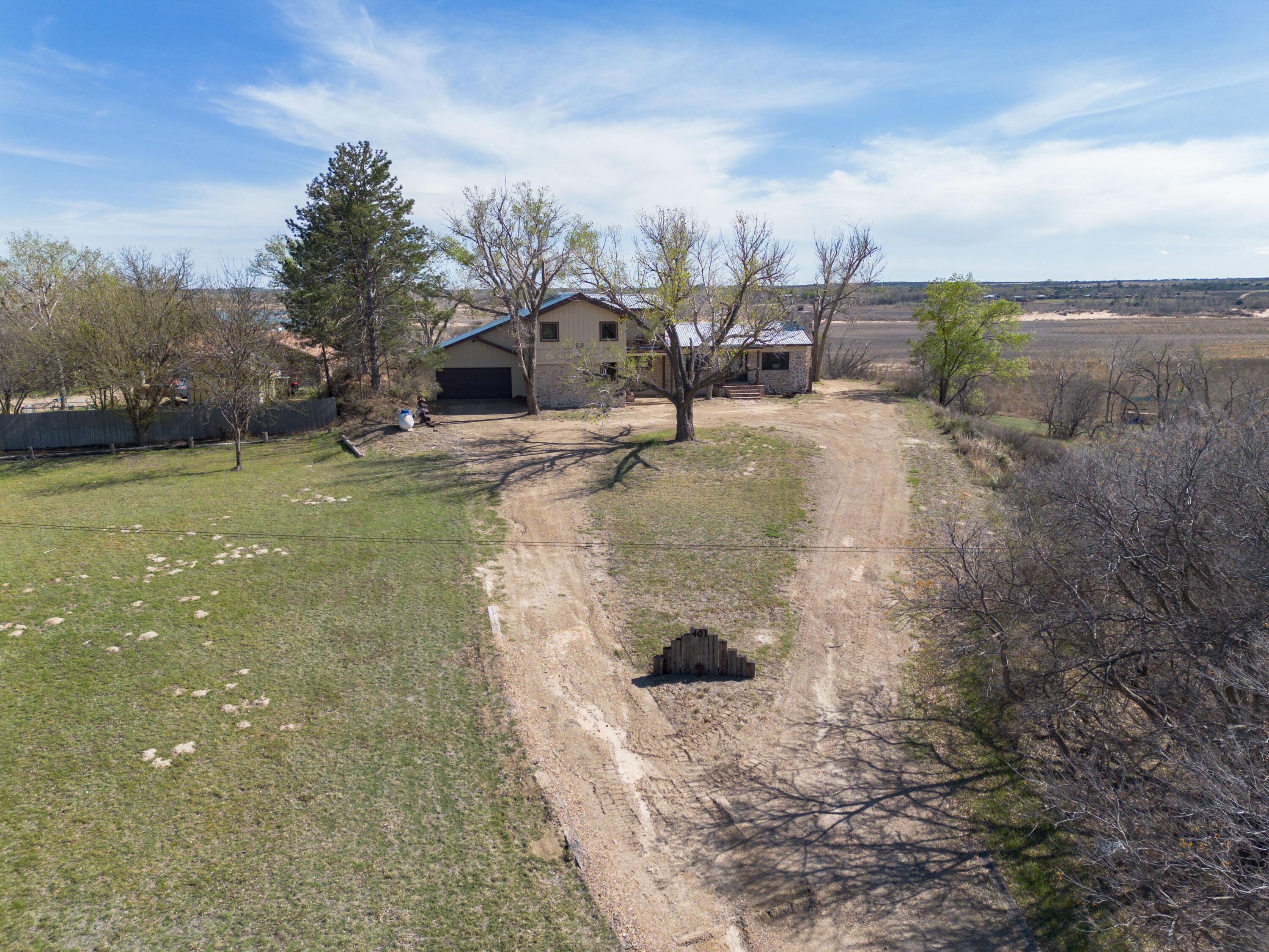 401 10 Bears Trail Howardwick, TX 79226 - Photo 3 of 71 a view of a wooden house with a yard