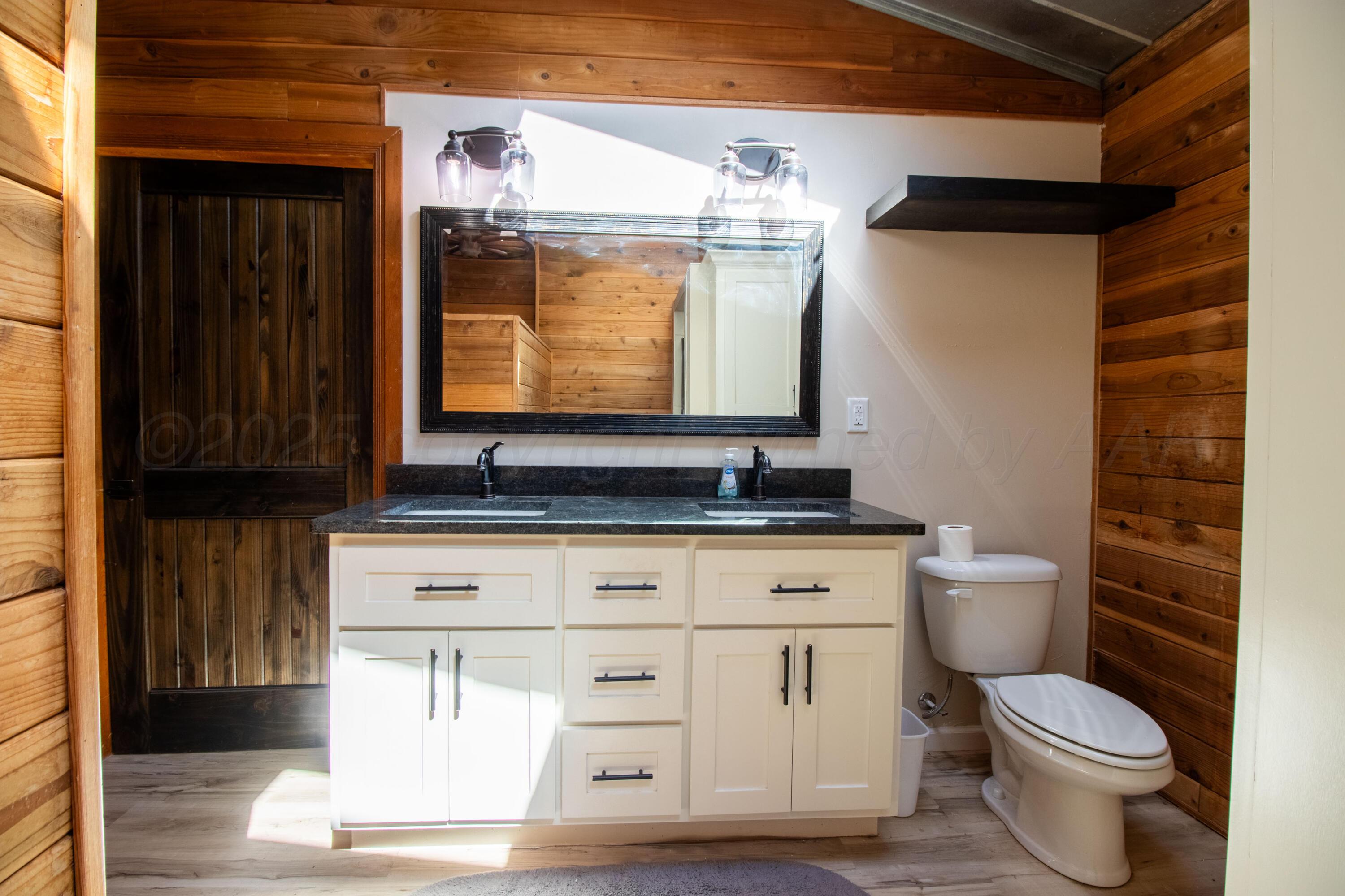 401 10 Bears Trail Howardwick, TX 79226 - Photo 34 of 71 a bathroom with a granite countertop toilet sink and mirror