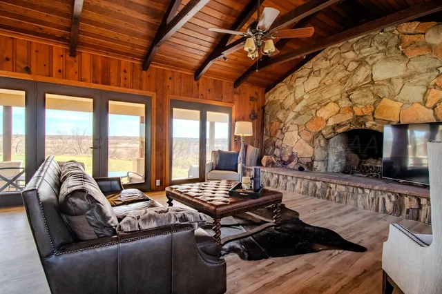 a living room with furniture and a floor to ceiling window