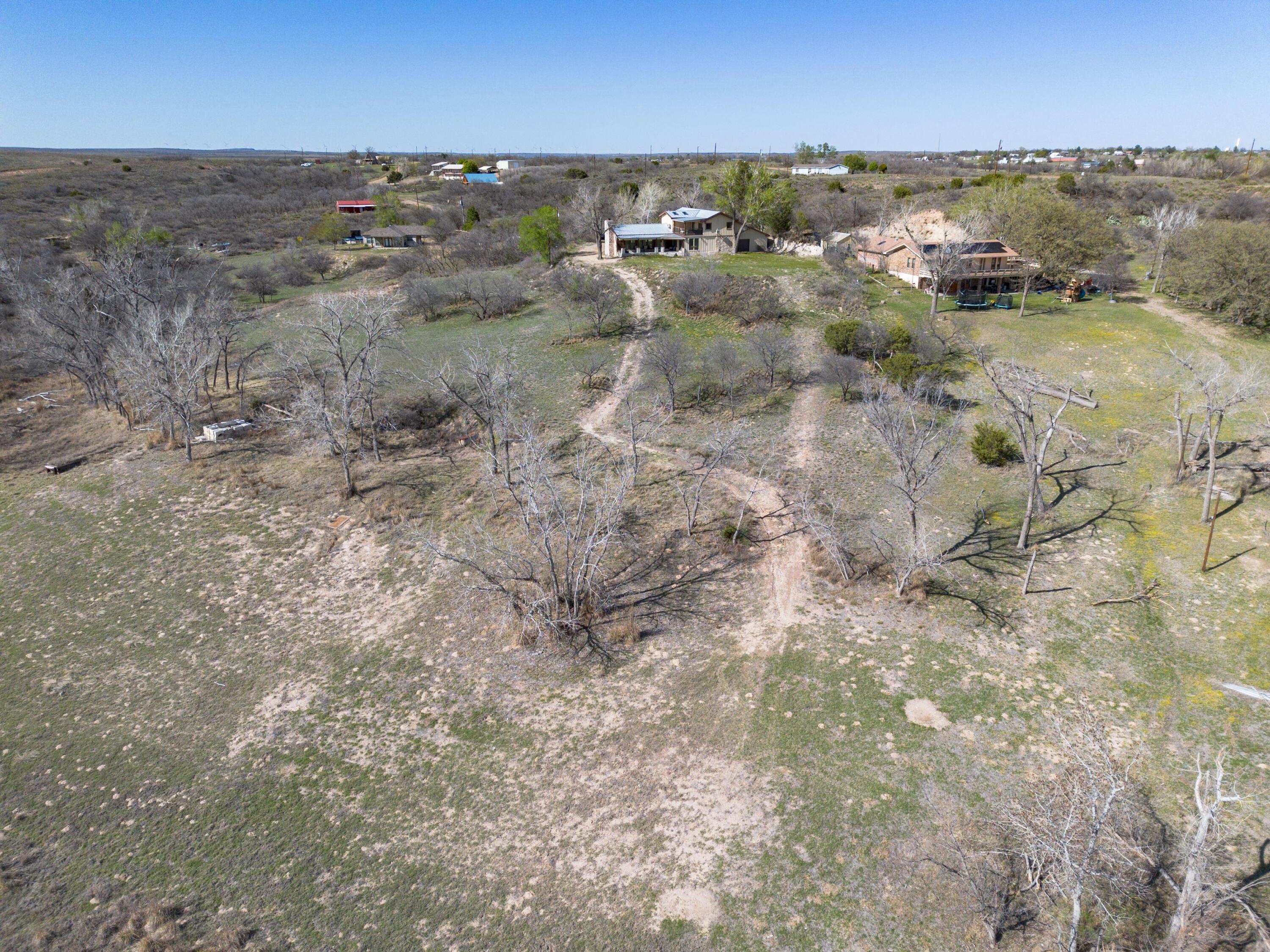 401 10 Bears Trail Howardwick, TX 79226 - Photo 63 of 71 an aerial view of residential houses with outdoor space and trees