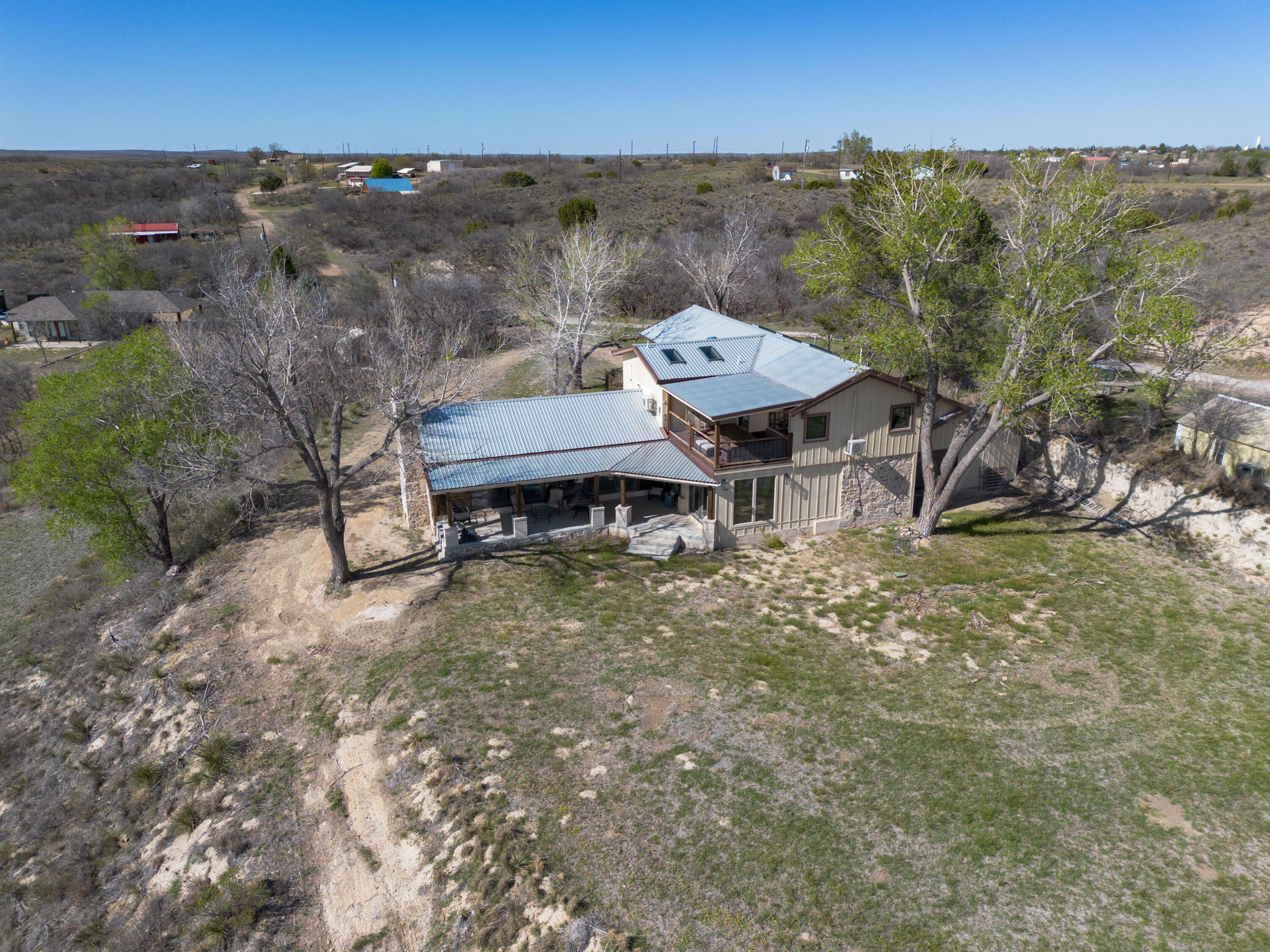 401 10 Bears Trail Howardwick, TX 79226 - Photo 64 of 71 an aerial view of a house with a yard and lake view