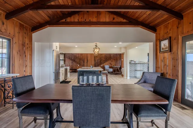 a view of a dining room with furniture and a window