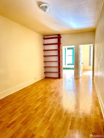 a kitchen with a refrigerator a stove top oven and a window