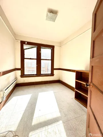 a bathroom with a granite countertop sink and a large mirror next to a window