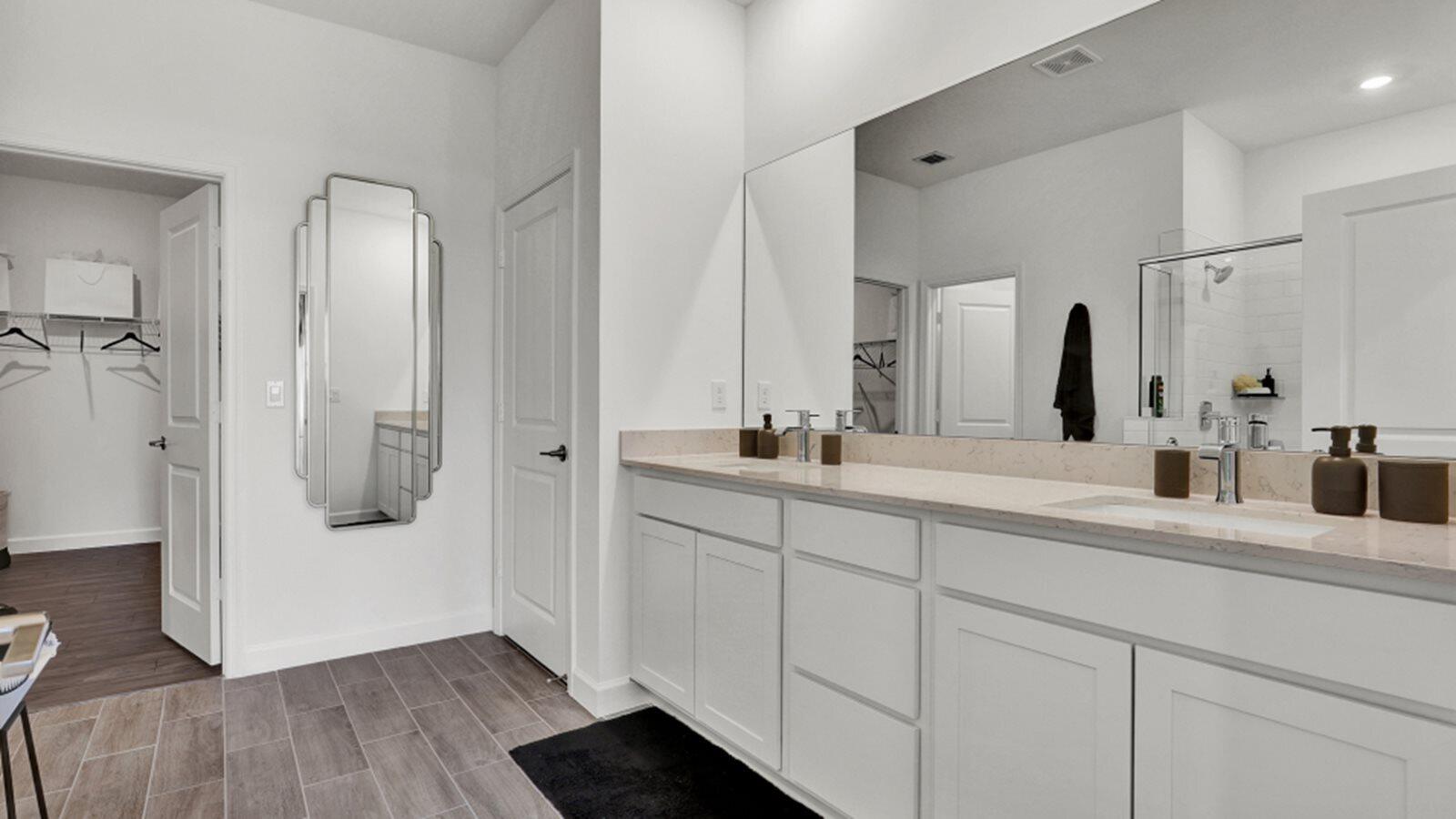 19781 Whispering Creek Road Loxahatchee, FL 33470 - Photo 10 of 22 a bathroom with a double vanity sink and mirror