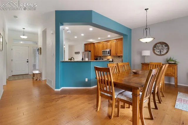a view of a dining room with furniture and wooden floor