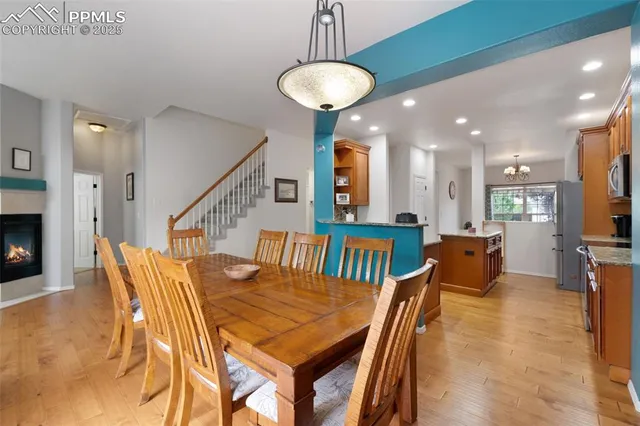 a dining room with furniture and wooden floor