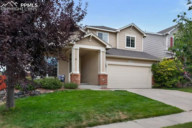 a front view of house with yard and green space