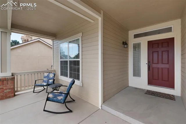a view of a door and chair in the back yard of the house