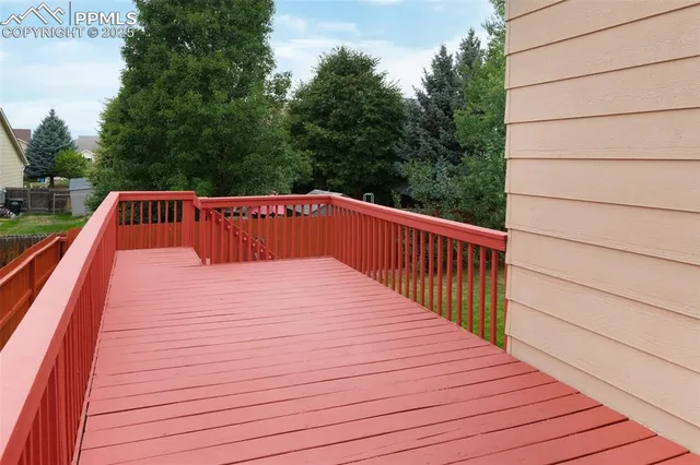 a terrace view with wooden floor and fence