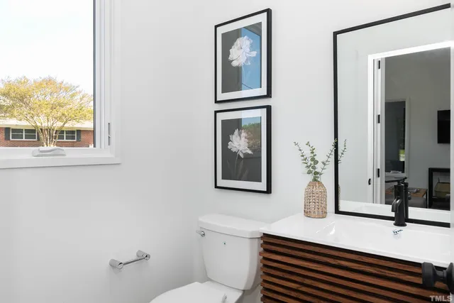 a bathroom with a sink a toilet and mirror