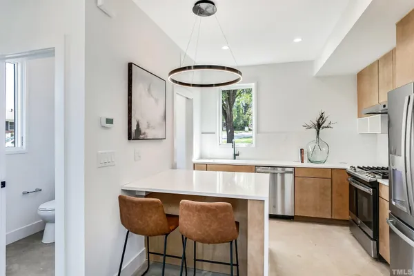 a kitchen with stainless steel appliances a sink and a refrigerator