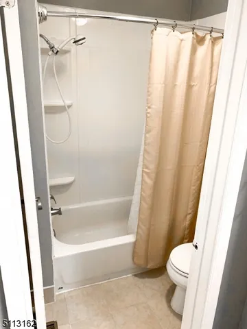 a bathroom with a shower and a toilet