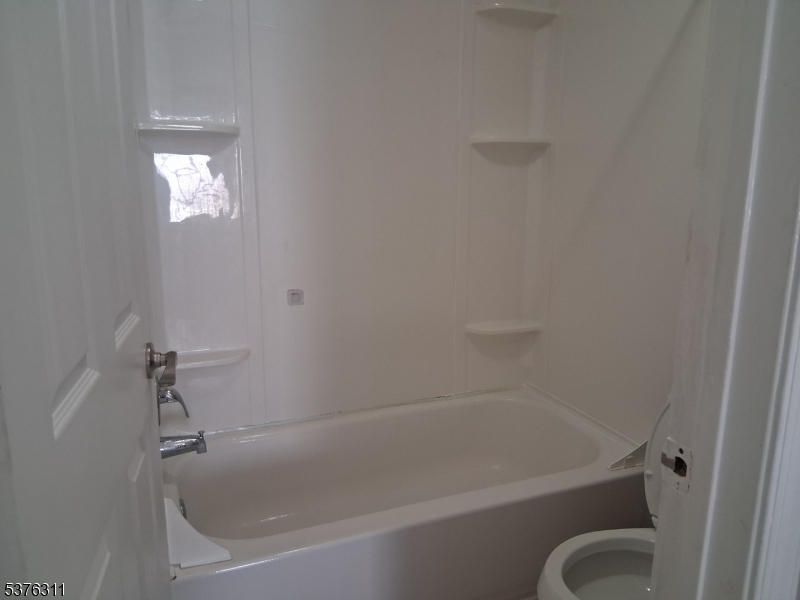 25 Stevens Court Bedminster, NJ 07921 - Photo 19 of 30 a white bath tub sitting next to a shower