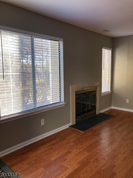 25 Stevens Court Bedminster, NJ 07921 - Photo 6 of 30 a view of empty room with wooden floor and fireplace