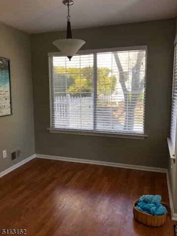 a room with wooden floor and a window