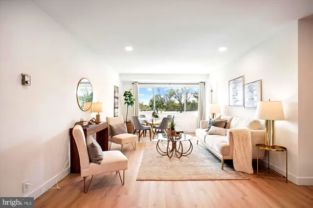 a living room with furniture a fireplace and a table