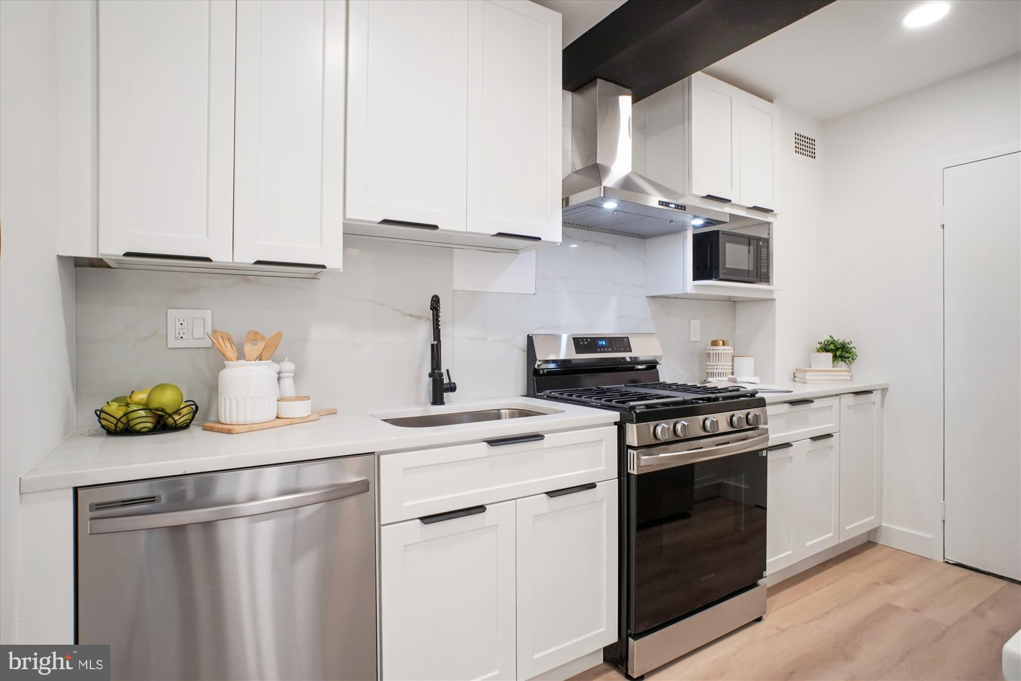 4201 Cathedral Avenue Northwest, Unit 1209W Washington, DC 20016 - Photo 11 of 46 a kitchen with stainless steel appliances a stove a white cabinets and a sink