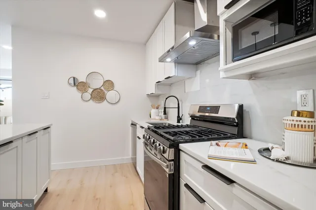 a kitchen with stainless steel appliances granite countertop a stove and a sink