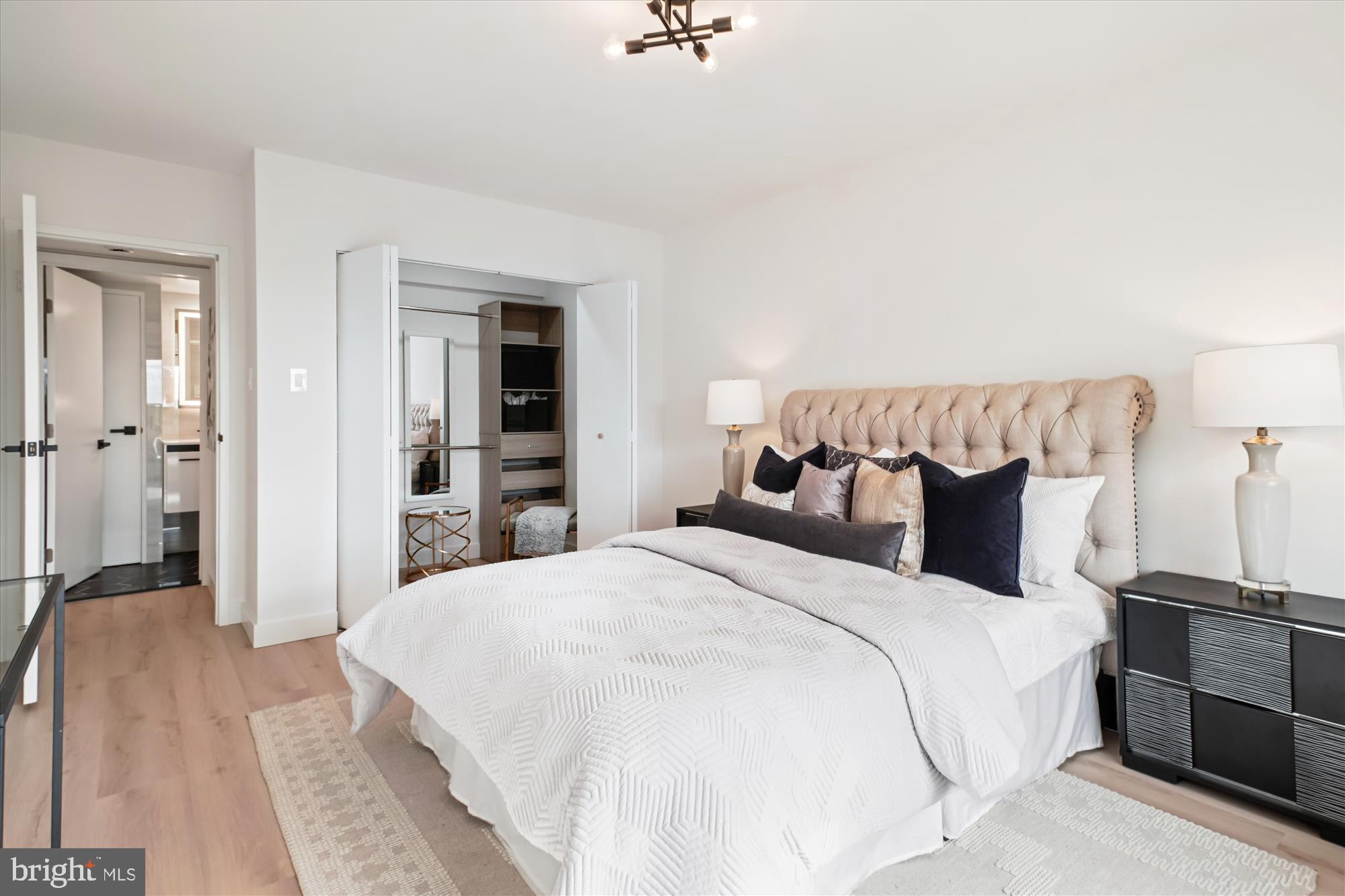 4201 Cathedral Avenue Northwest, Unit 1209W Washington, DC 20016 - Photo 15 of 46 a spacious bedroom with a bed and a table