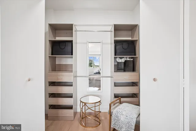 a kitchen with a refrigerator and white cabinets