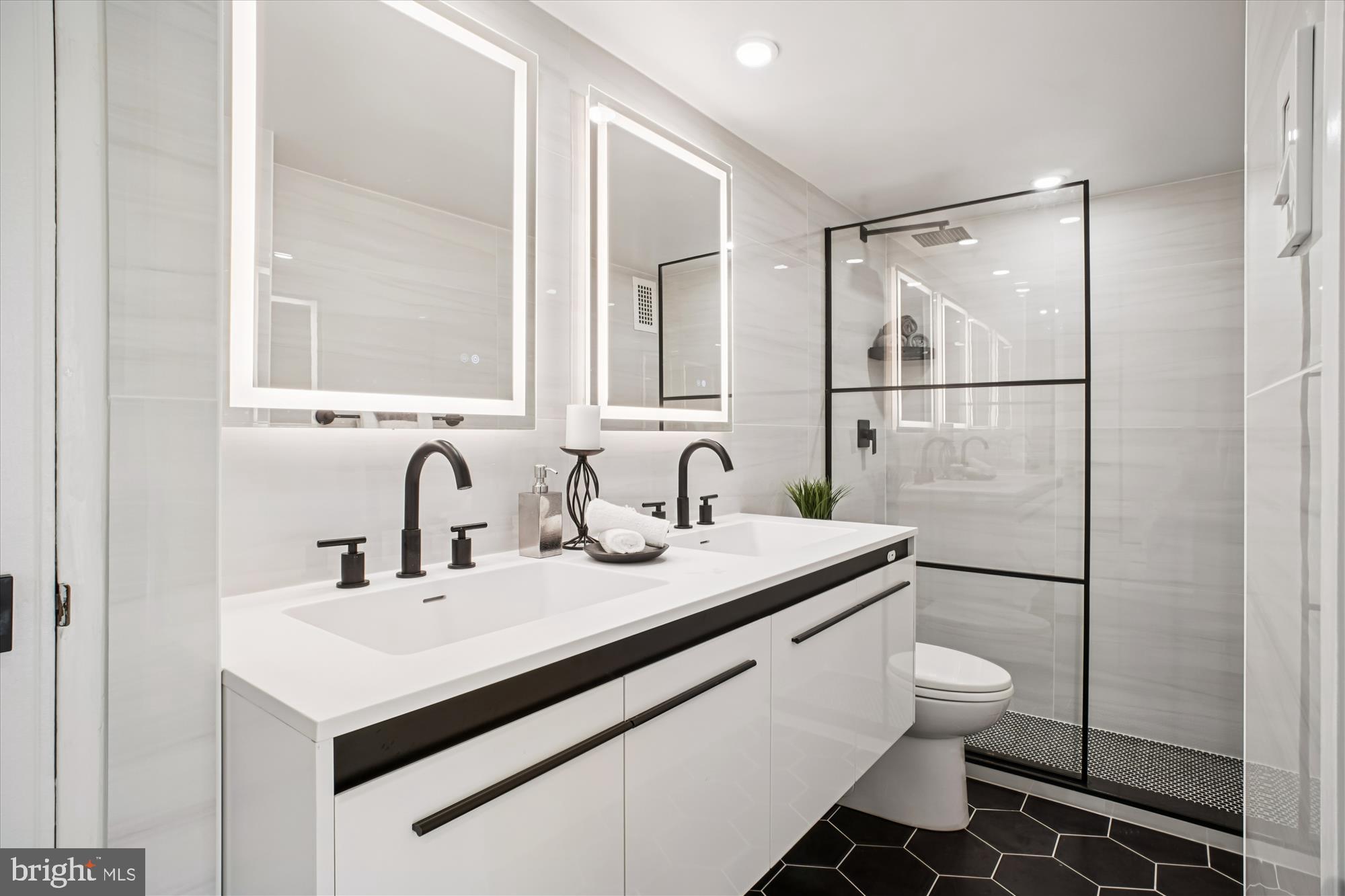 4201 Cathedral Avenue Northwest, Unit 1209W Washington, DC 20016 - Photo 17 of 46 a bathroom with a sink toilet and shower
