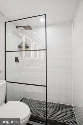 a bathroom with a toilet and a shower