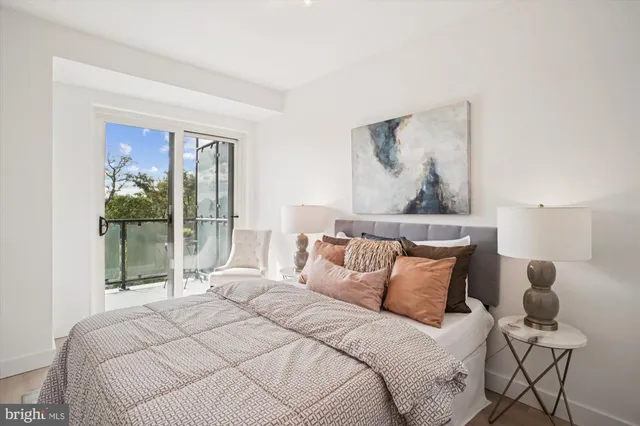 a bedroom with a bed and large window