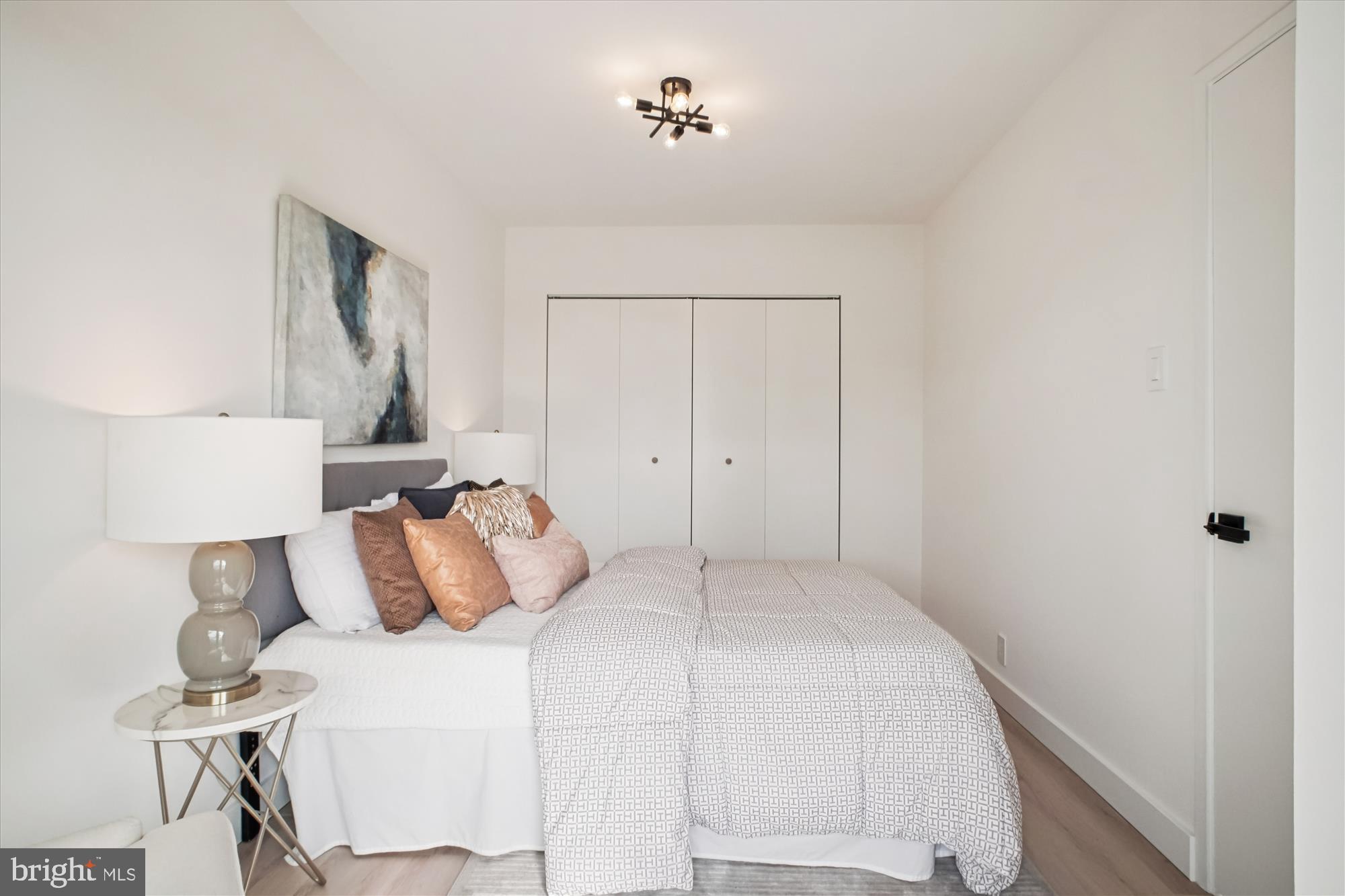 4201 Cathedral Avenue Northwest, Unit 1209W Washington, DC 20016 - Photo 21 of 46 a bedroom with a bed and a table