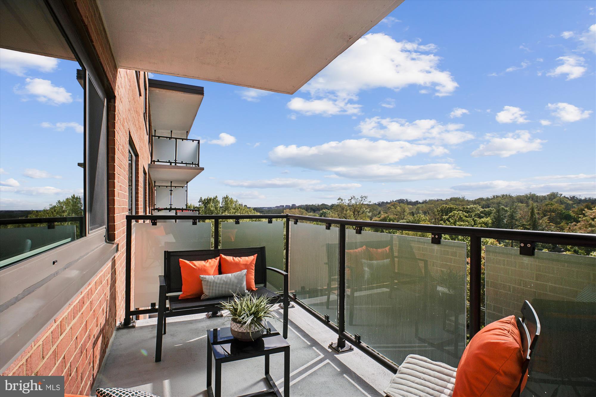 4201 Cathedral Avenue Northwest, Unit 1209W Washington, DC 20016 - Photo 24 of 46 a balcony with couple of chairs and wooden floor