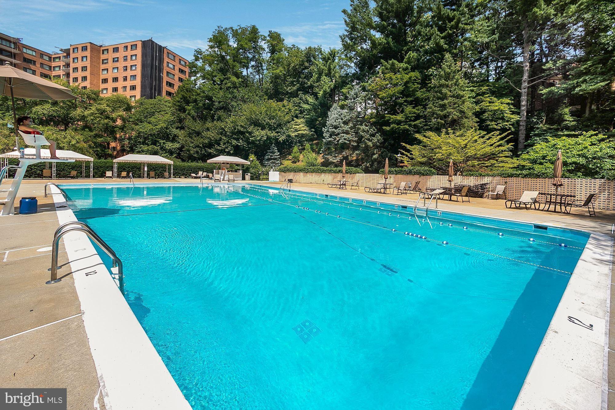 4201 Cathedral Avenue Northwest, Unit 1209W Washington, DC 20016 - Photo 31 of 46 a view of a swimming pool with a patio