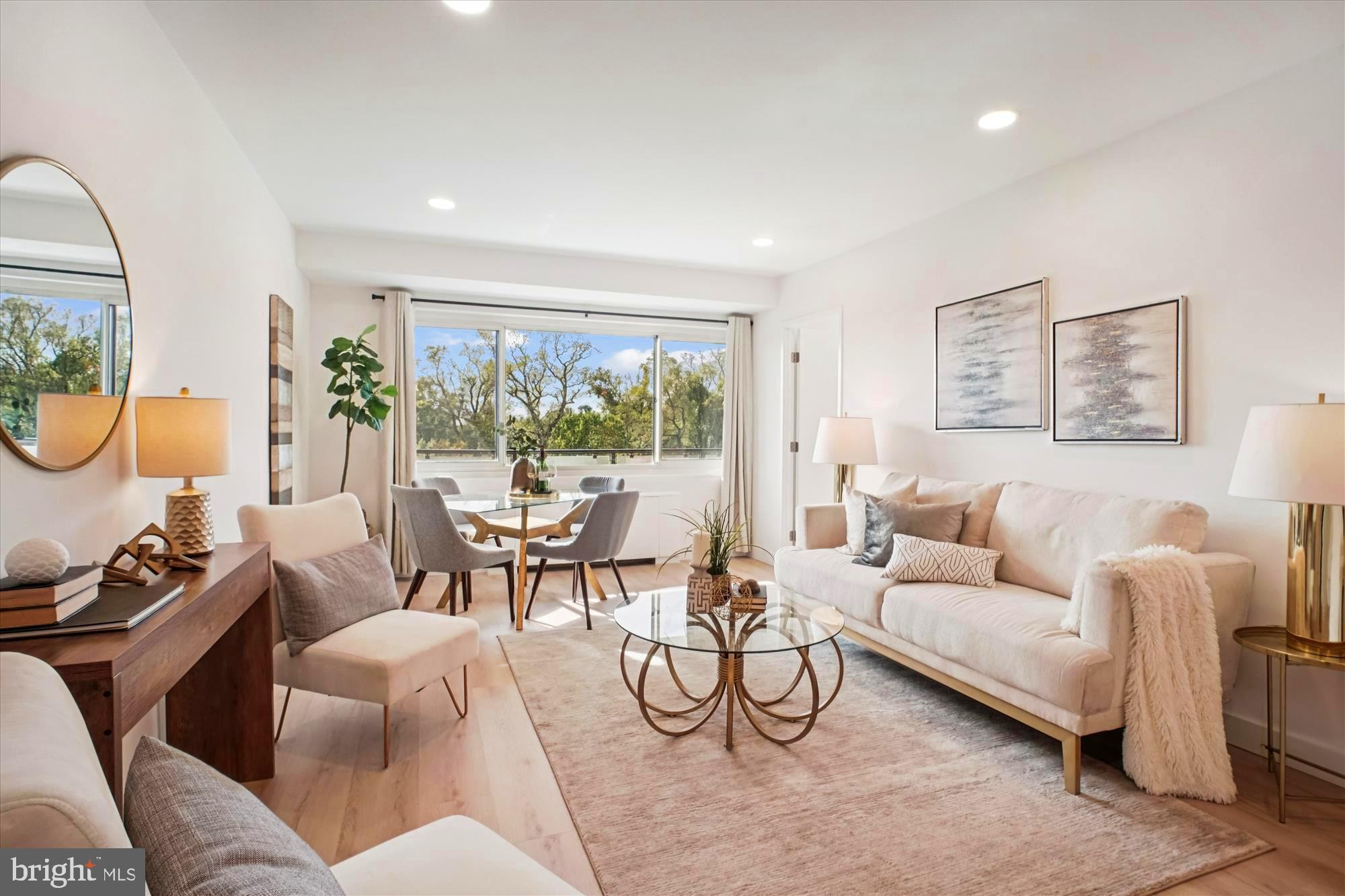 4201 Cathedral Avenue Northwest, Unit 1209W Washington, DC 20016 - Photo 6 of 46 a living room with furniture and a large window