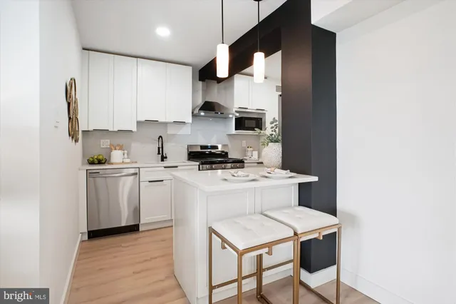 a kitchen with a stove cabinets and a refrigerator