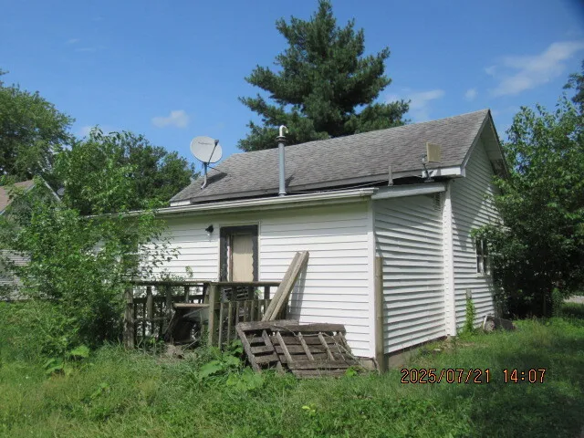 a view of backyard of house with outdoor seating and green space