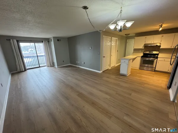 a view of a livingroom with a furniture wooden floor and window