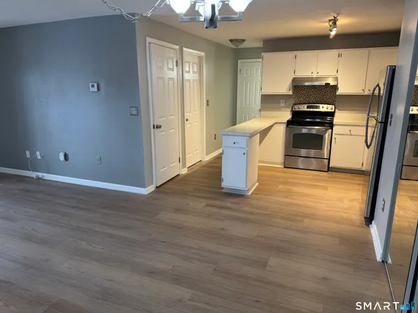 a kitchen with stainless steel appliances granite countertop a refrigerator and a stove top oven