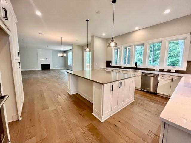 2626 Salient Apex, NC 27523 - Photo 14 of 52 a kitchen with a stove a sink a kitchen island with wooden floor and cabinets